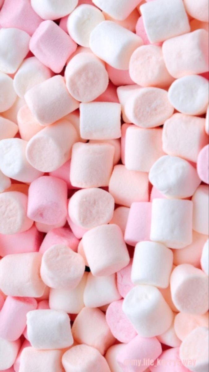 pink and white marshmallows are scattered together