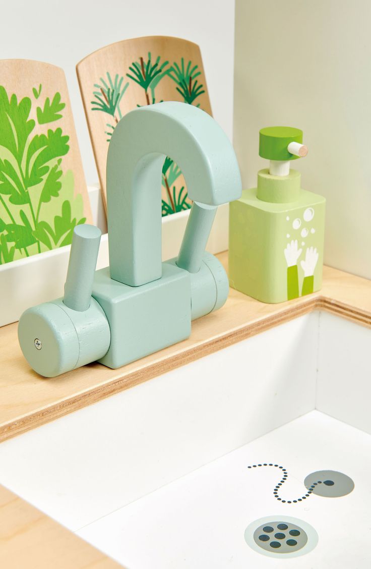 a bathroom sink with soap dispenser and toothbrush holder