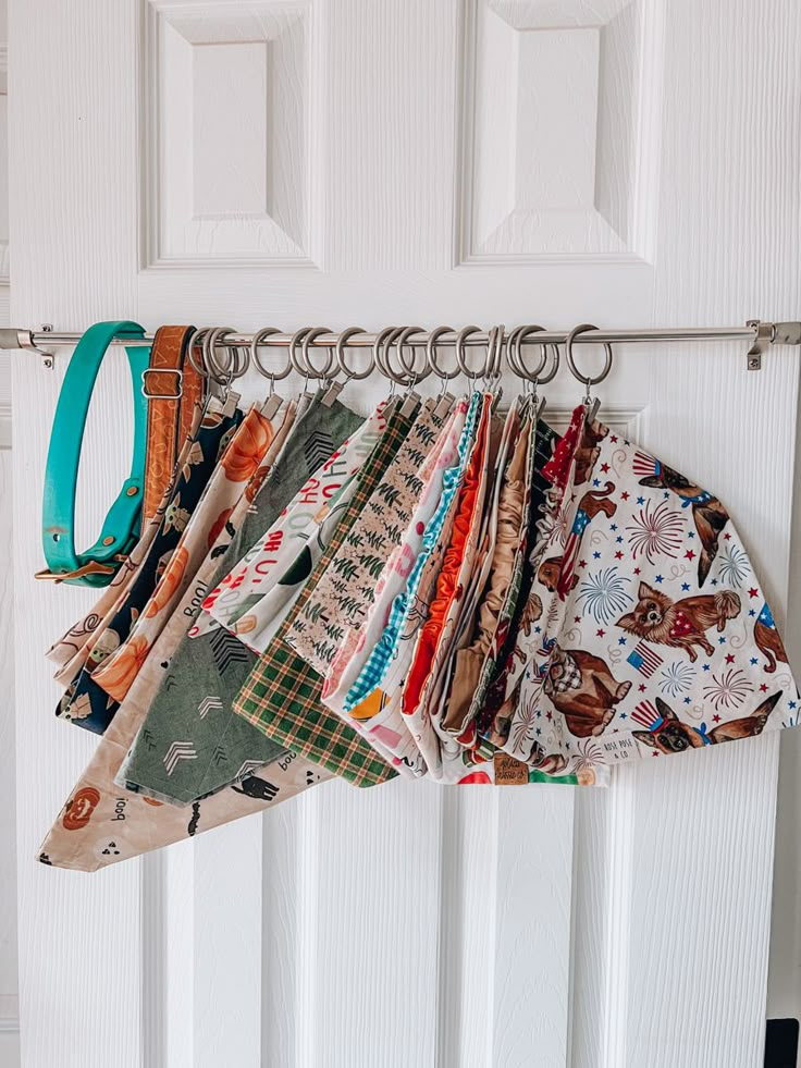 a bunch of cloths are hanging on a clothes line in front of a door