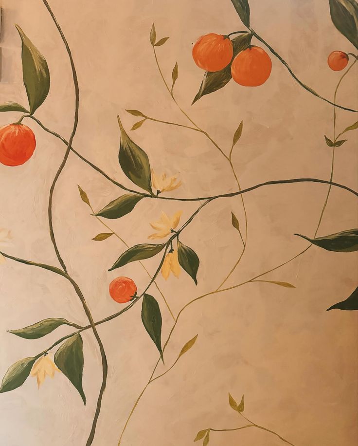 a painting of oranges and green leaves on a wall with a light switch box