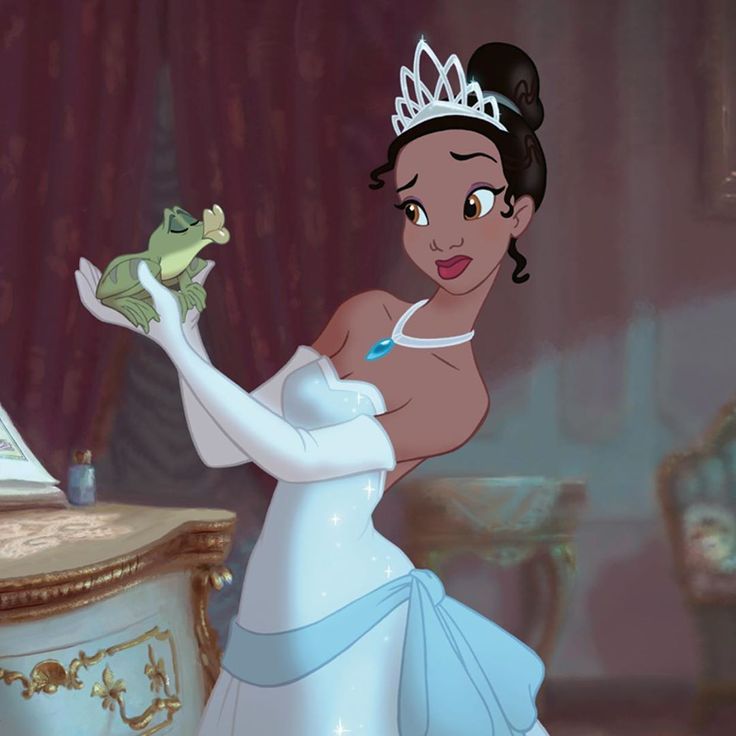 the princess and the frog is holding a frog on her hand while standing in front of a desk