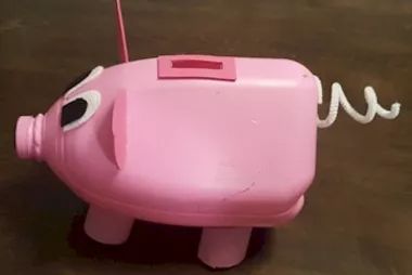 a pink toy with eyes and a cord attached to it