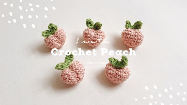 four crocheted peaches with green leaves on them sitting next to each other