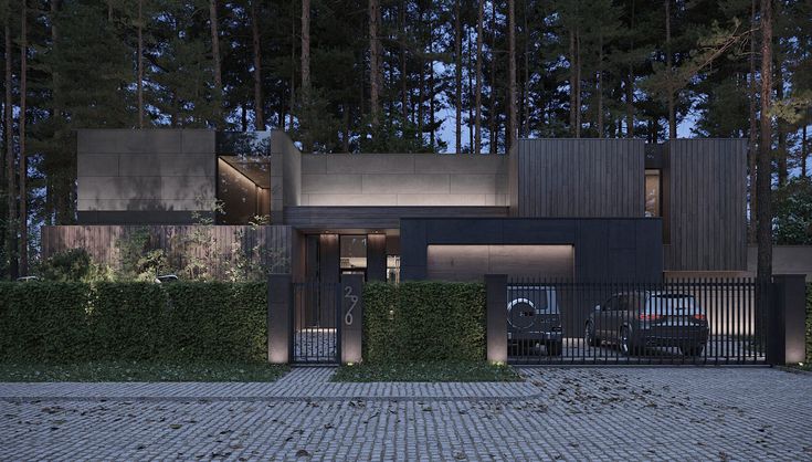 a car is parked in front of a house with tall trees behind it at night