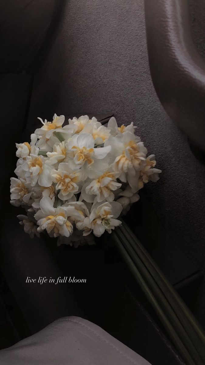 a bouquet of flowers sitting on top of a car seat