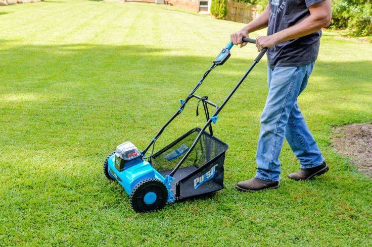 a man is mowing the grass with his lawnmower