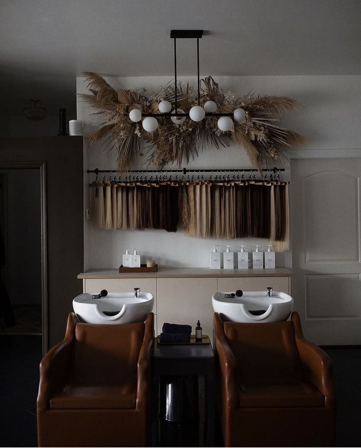 two white sinks sitting next to each other on top of a wooden table in front of a window