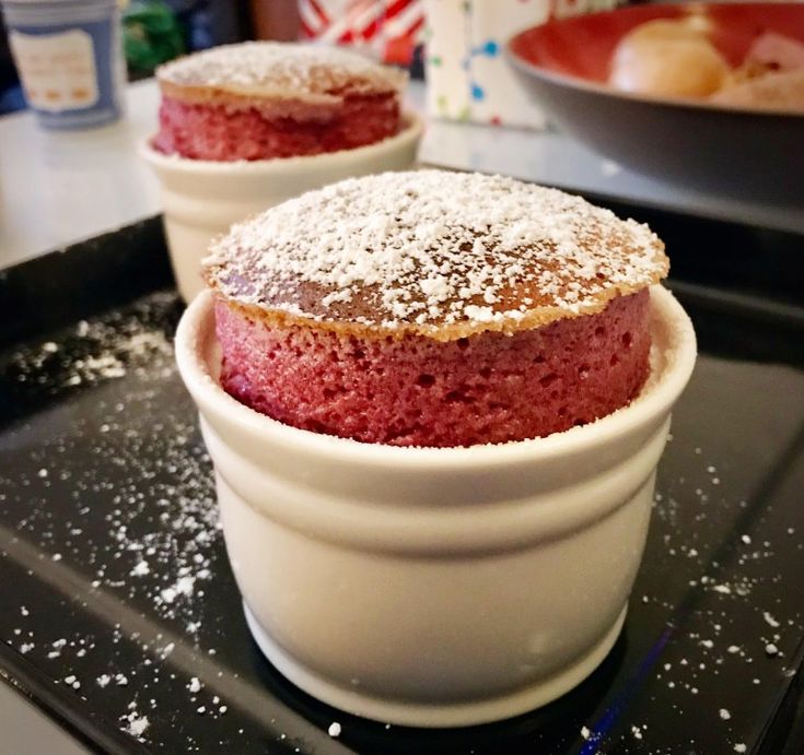 two desserts are sitting in bowls on the stove