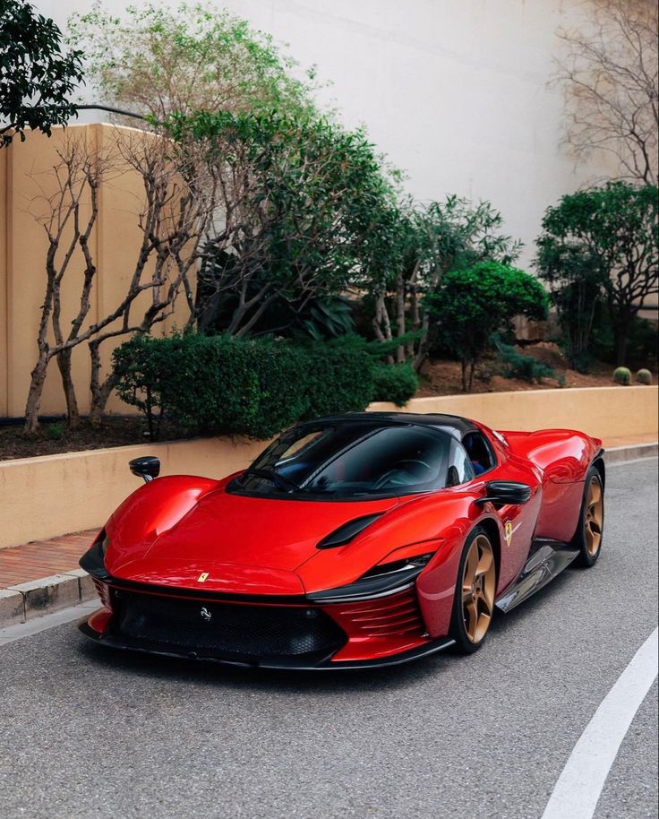 a red sports car driving down the street