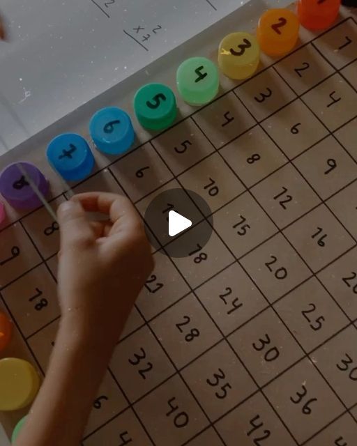 a person is playing a game with numbers on the board and letters written in different colors