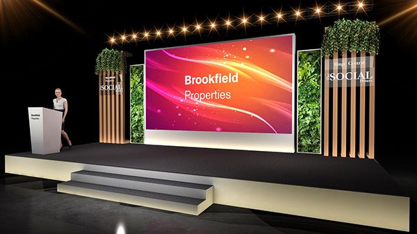 a man standing at a podium in front of a screen with the words brookfield properties on it