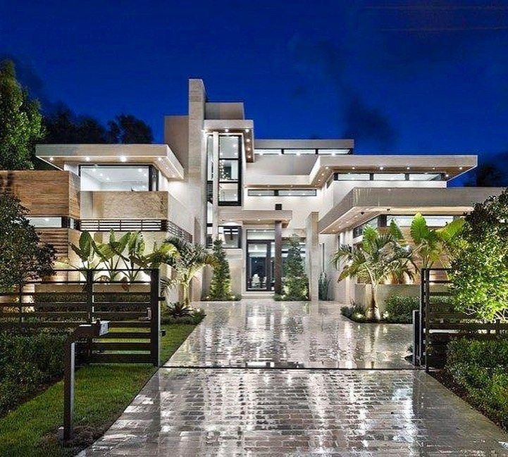 the entrance to a modern house at night