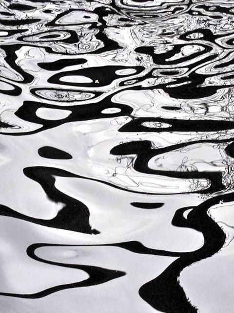 black and white photograph of water with ripples in the water, looking like abstract art