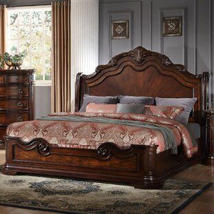 a bedroom scene with focus on the bed and dresser