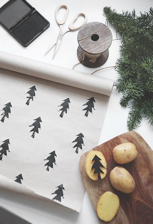 a cutting board topped with potatoes and pine trees