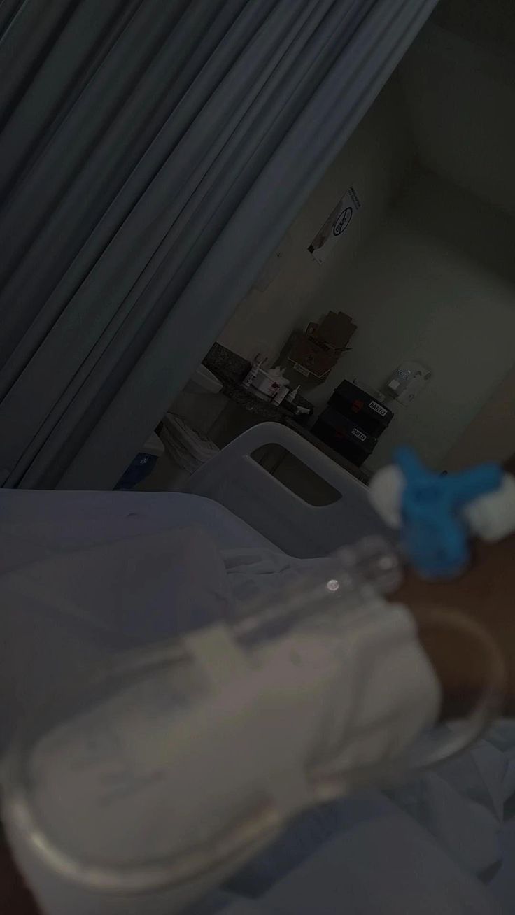 a person in a hospital bed with an iv tube attached to their arm and hand