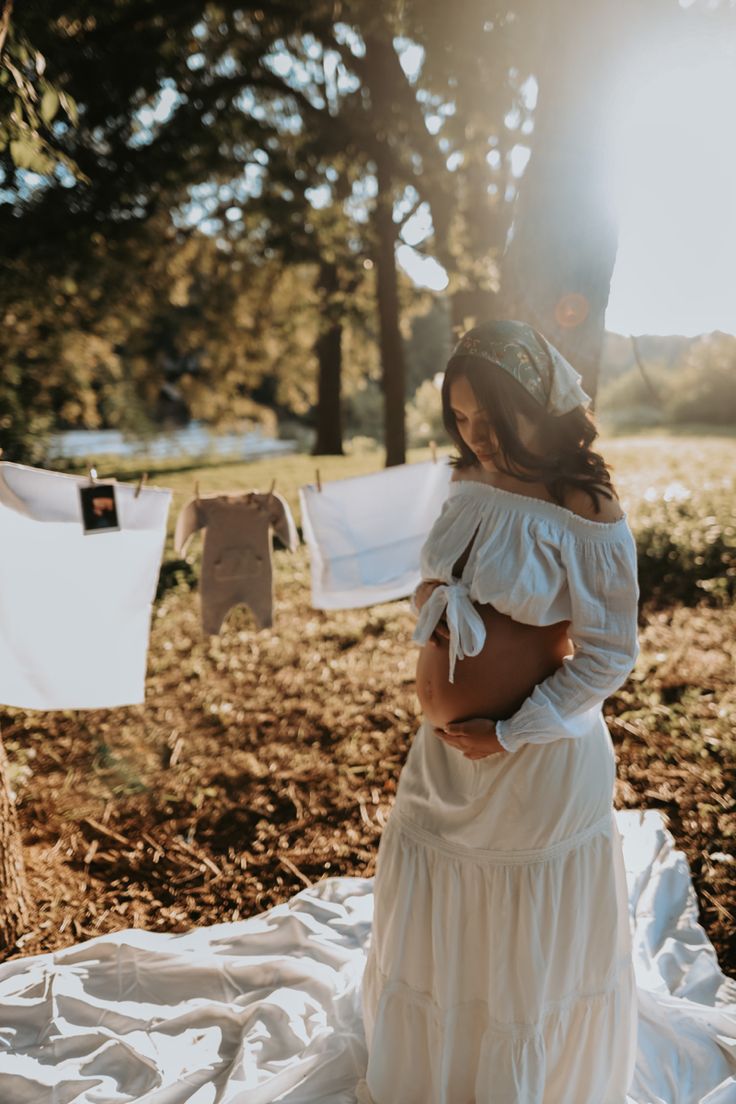 a woman in a white dress standing on a blanket