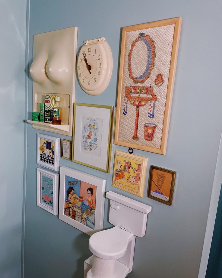 there is a toilet and pictures on the wall