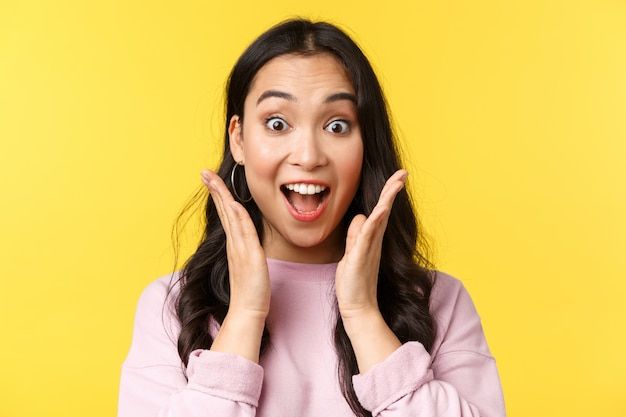 a woman making a funny face while holding her hands in front of her face with both hands