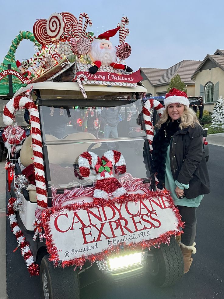 a woman standing next to a golf cart decorated with candy canes