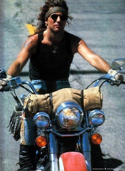 a woman riding on the back of a motorcycle