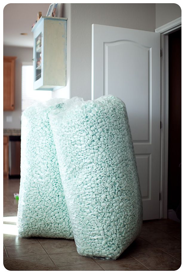 two large pillows sitting on the floor in front of a door with a mirror above them