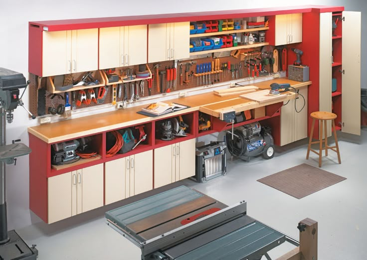 an organized garage with lots of tools and equipment on the shelves, including workbench