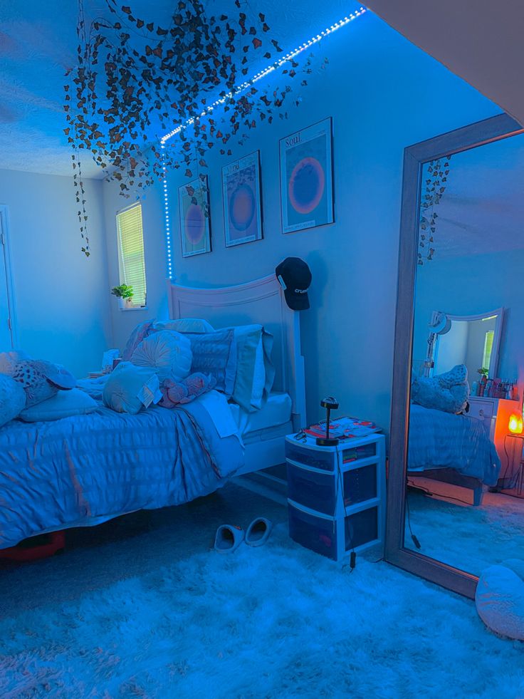 a bed room with a large mirror on the wall and lights hanging from the ceiling