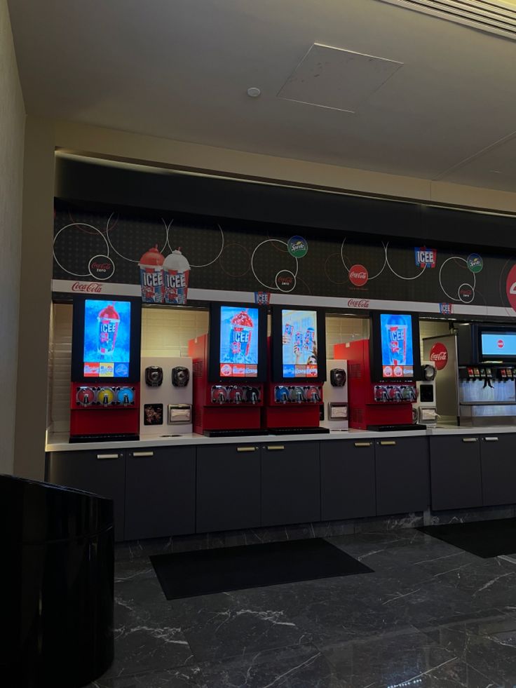 a row of vending machines sitting next to each other in front of a wall