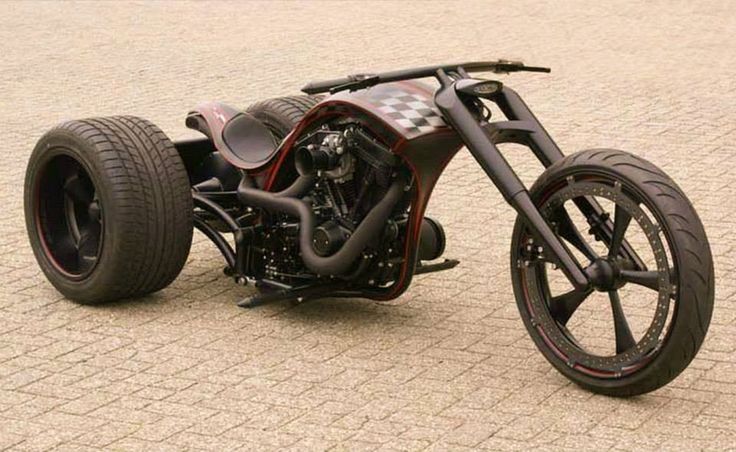 an unusual looking motorcycle is parked on the street