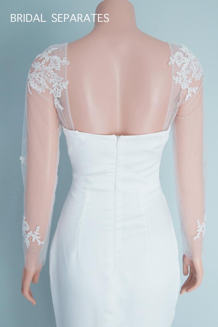 the back of a brides dress with white lace on it, and an open neckline