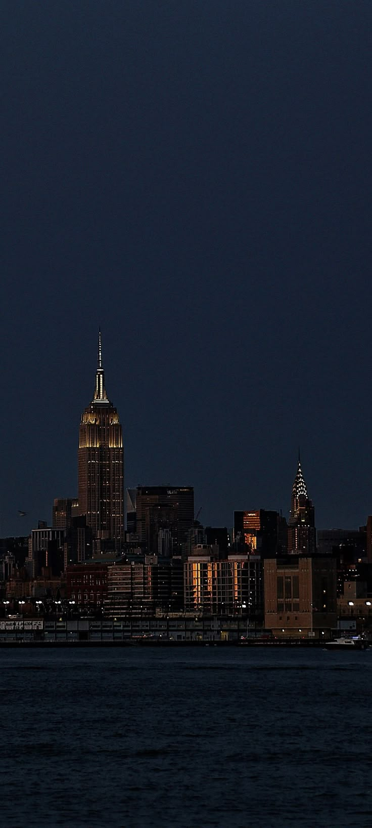 an airplane is flying over the city at night