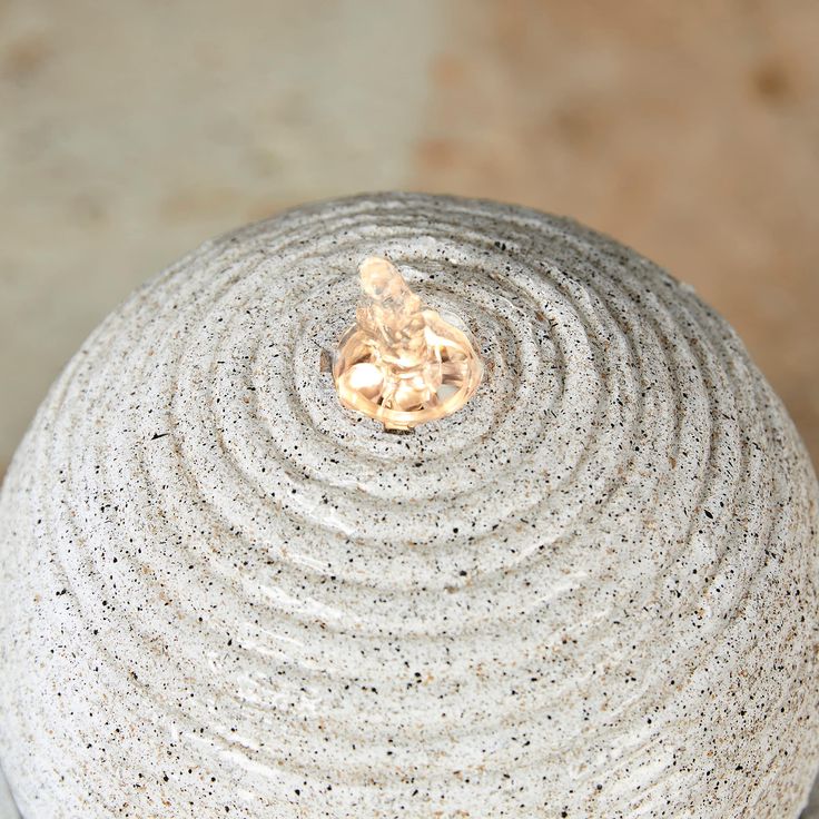 a white vase sitting on top of a table