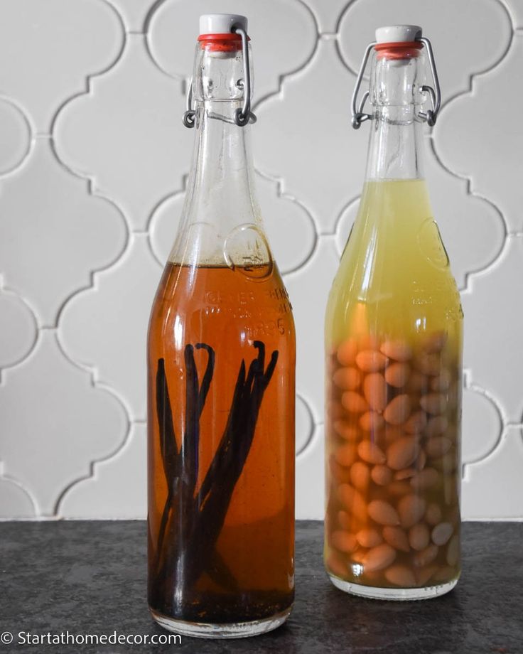 two bottles filled with liquid sitting next to each other