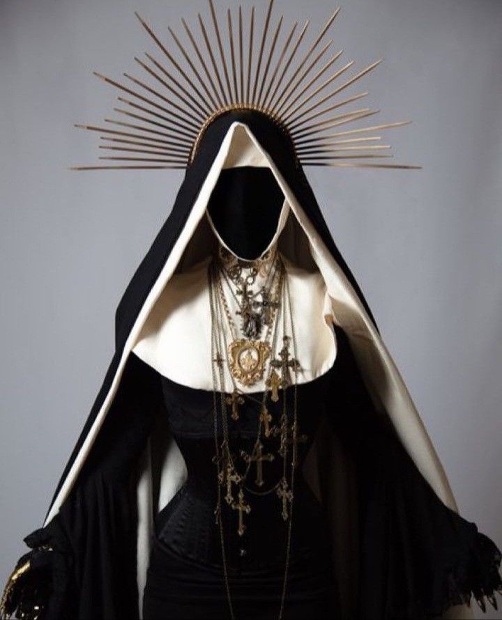 an image of a woman wearing a black dress with gold accents on her face and hood