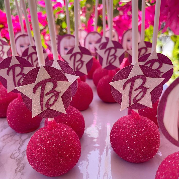 pink cake pops decorated with stars and sparkles