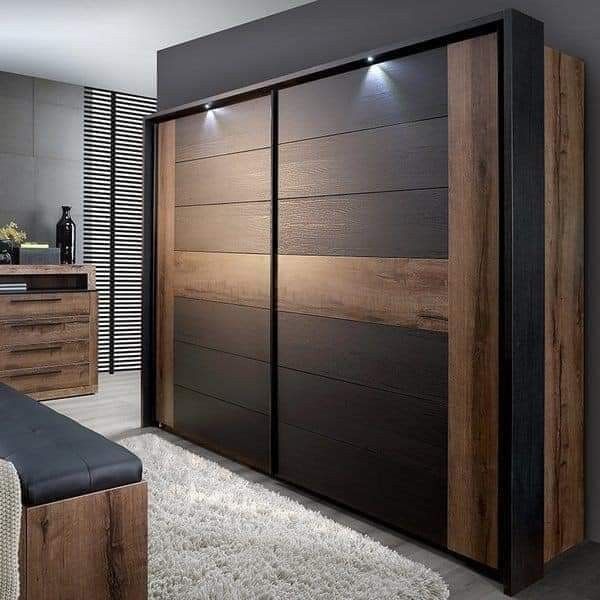 an image of a bedroom setting with wardrobes in the middle and lights above it