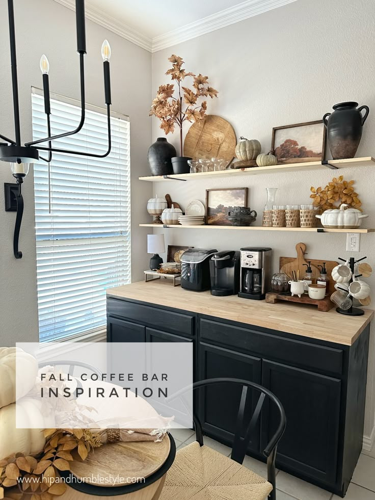 a kitchen with black cabinets and shelves filled with items on top of the cupboards