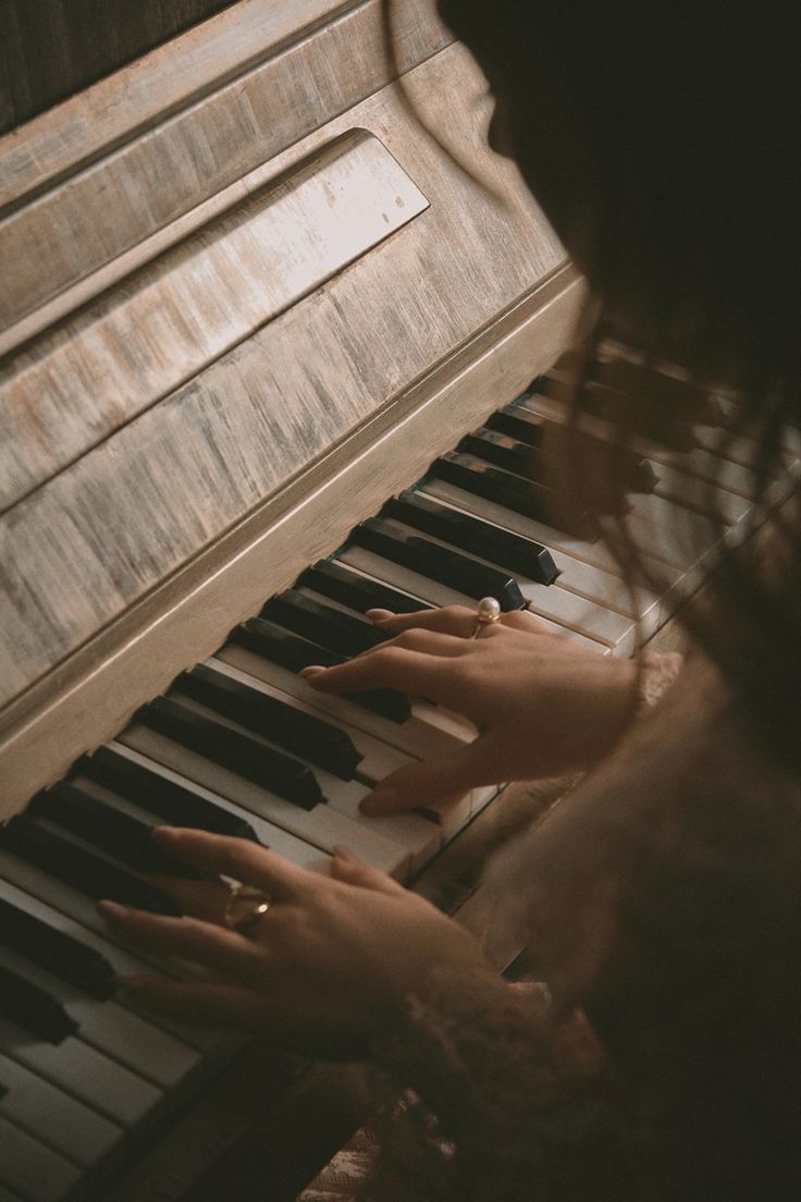 a woman is playing the piano with her hands