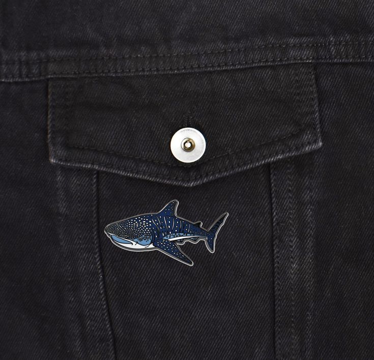 a shark sticker on the back of a black jeanie jeans pocketed in