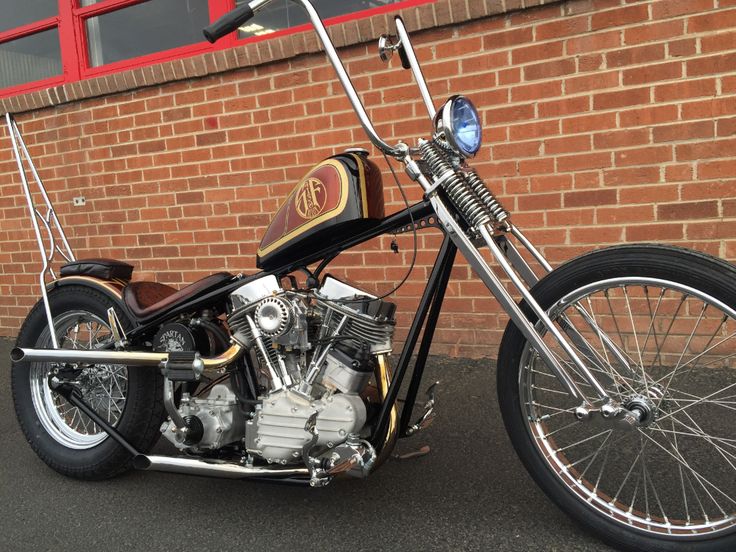 a motorcycle parked in front of a brick building