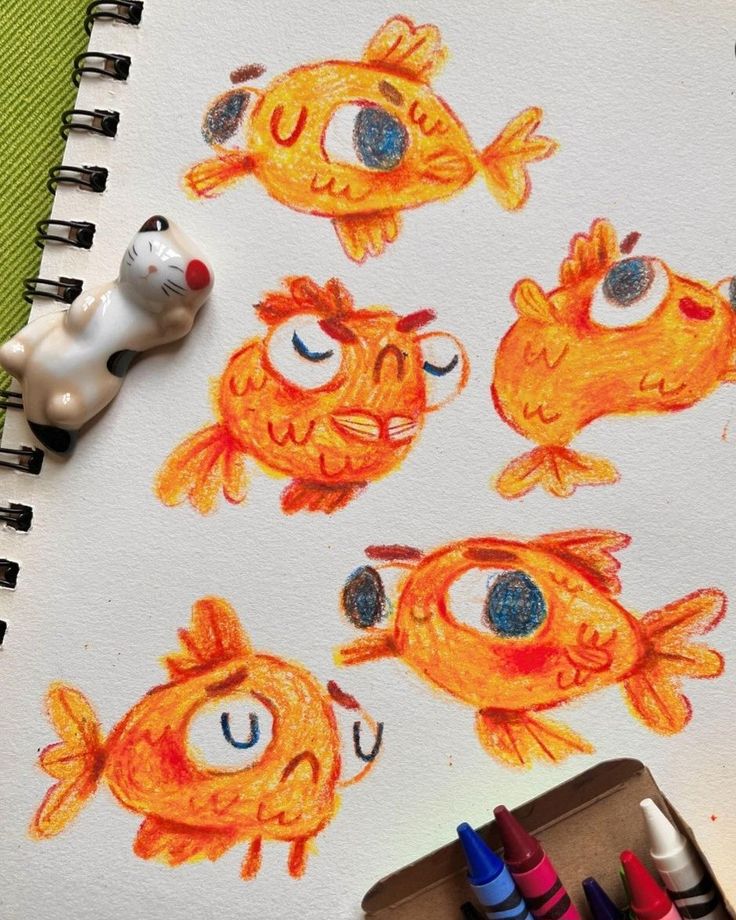 an image of children's drawings on paper with colored crayon pencils