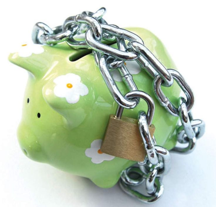 a green piggy bank chained to a chain with a padlock on it's side