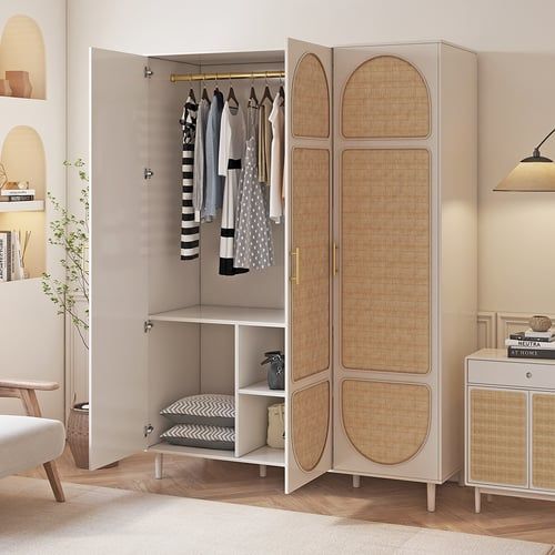 an open closet with clothes hanging on the door and shelves next to it in a living room