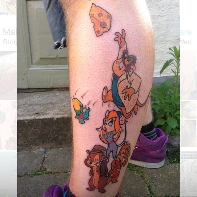 a cartoon character tattoo on the leg of a man