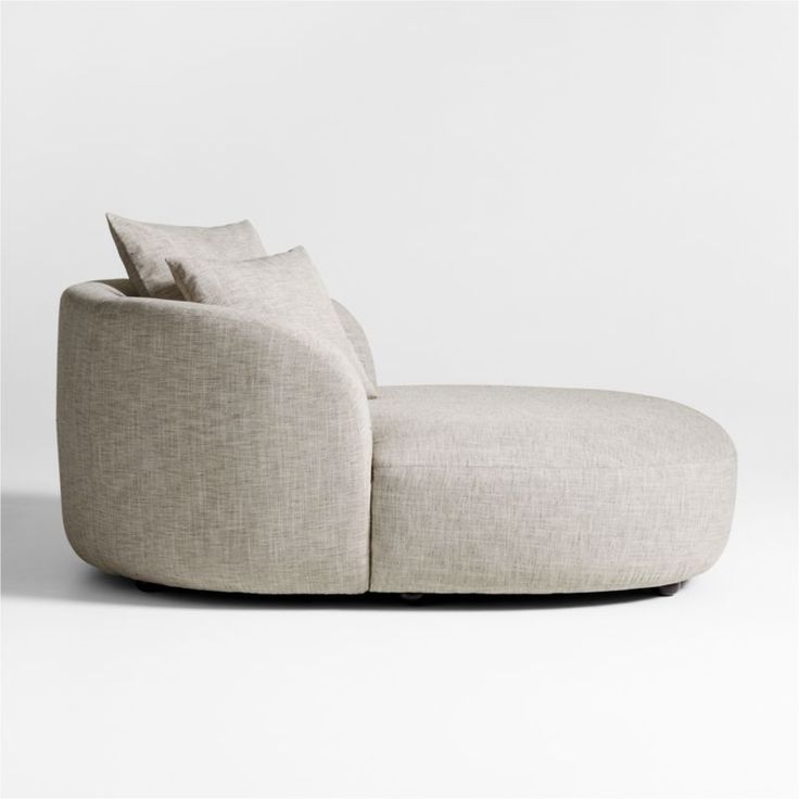 a white couch with two pillows on it's back and the seat upholstered