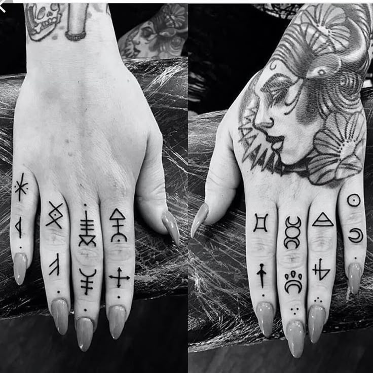 two hands with tattoos and symbols on them