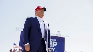 a man in a blue suit and red hat