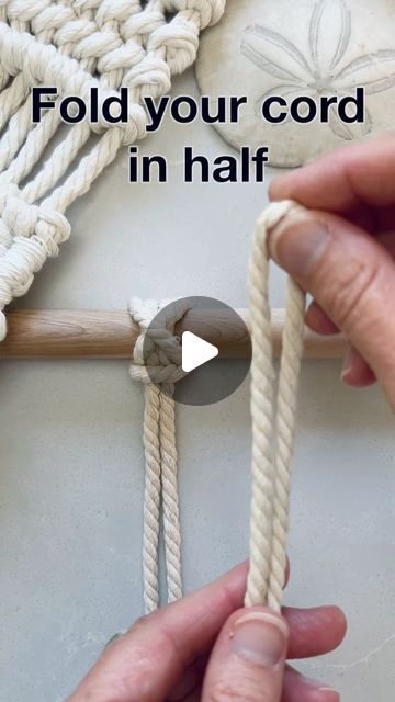 two hands holding rope with text that reads fold your cord in half