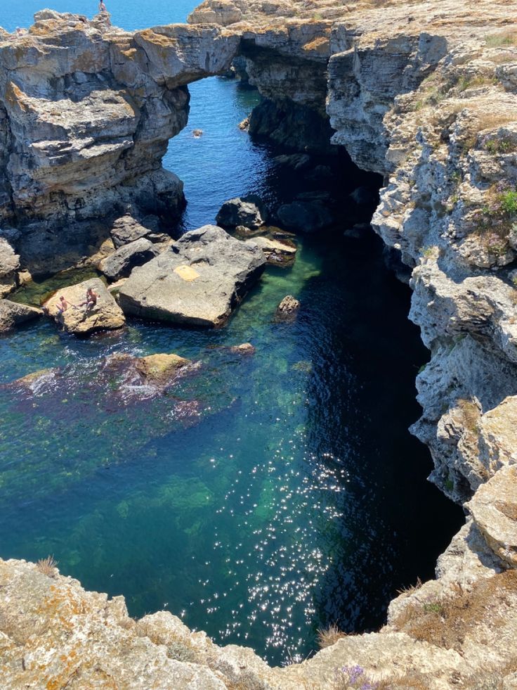 the water is clear and blue in this rocky area